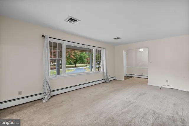 an empty room with a empty space and windows