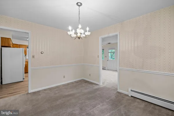 an empty room with chandelier fan