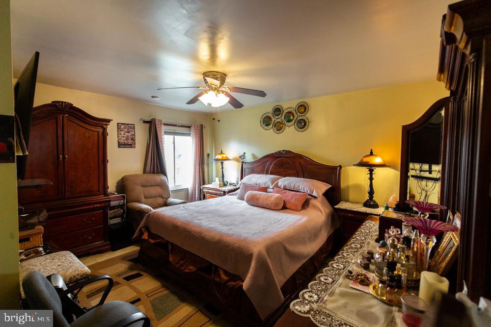 11200 Cherry Hill Road, Unit 54 Beltsville, MD 20705 - Photo 11 of 18 a bedroom with a bed and wooden floor