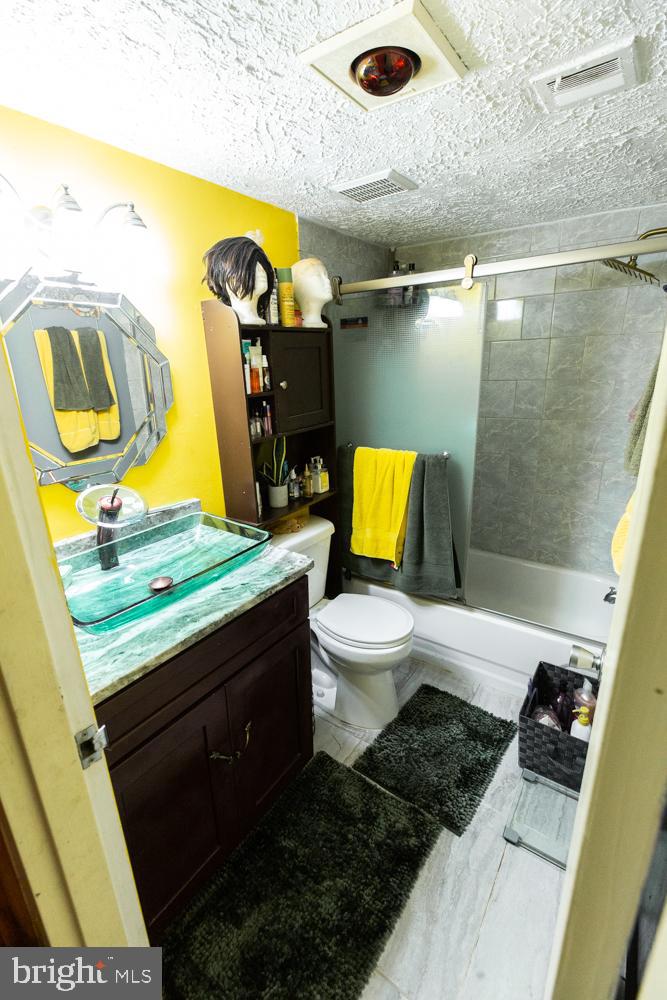 11200 Cherry Hill Road, Unit 54 Beltsville, MD 20705 - Photo 14 of 18 a bathroom with a sink a toilet and bathtub