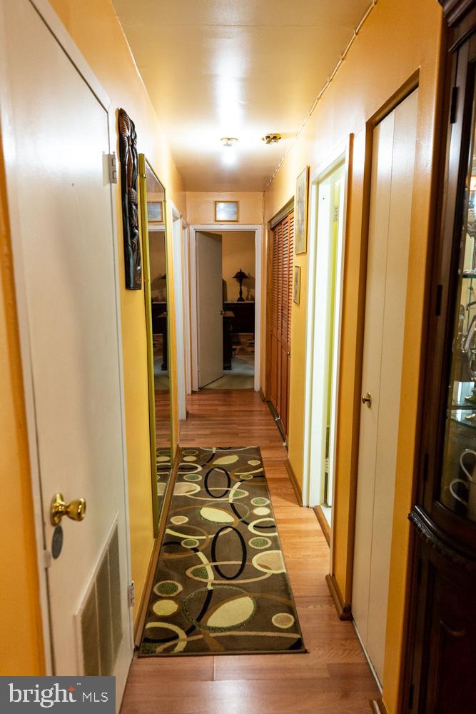 11200 Cherry Hill Road, Unit 54 Beltsville, MD 20705 - Photo 18 of 18 a view of a hallway with wooden floor and staircase