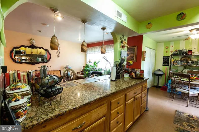 a kitchen with sink a mirror and cabinets
