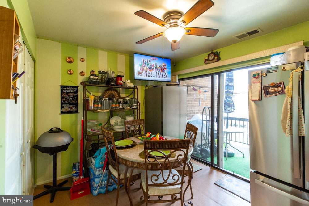 11200 Cherry Hill Road, Unit 54 Beltsville, MD 20705 - Photo 5 of 18 a view of a dining room with furniture window and outside view