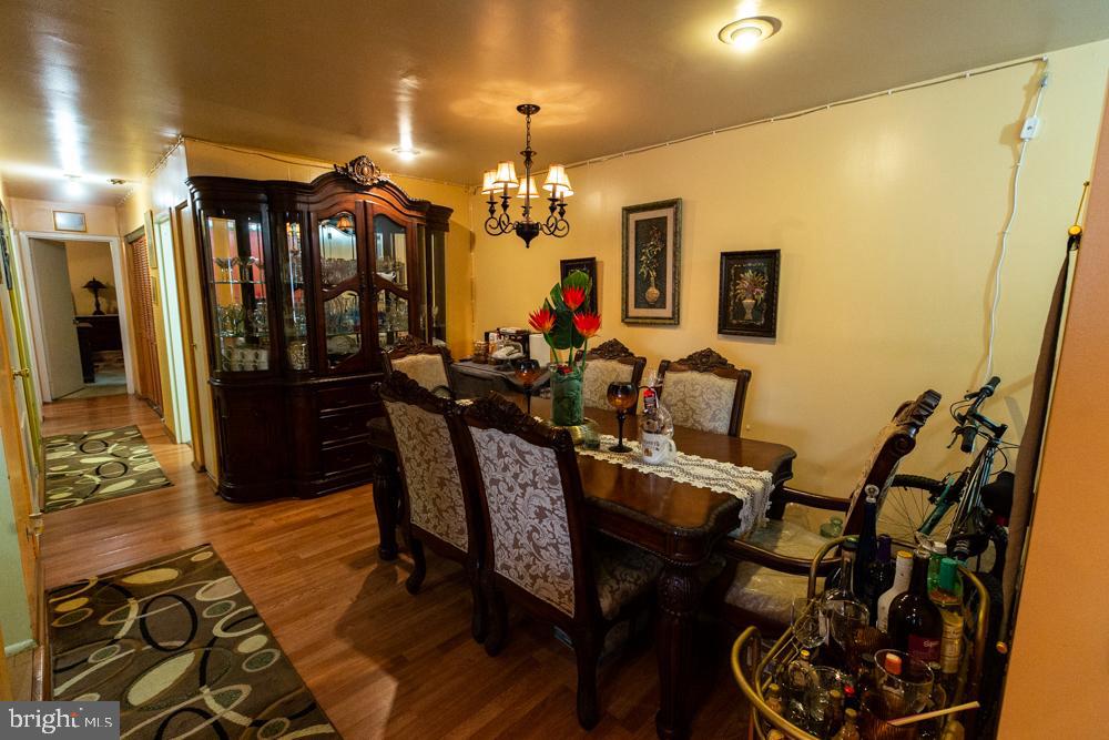 11200 Cherry Hill Road, Unit 54 Beltsville, MD 20705 - Photo 6 of 18 a view of a dining room with furniture and chandelier