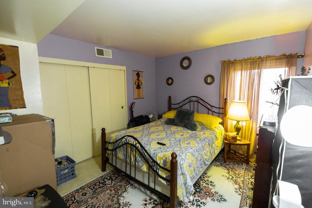 11200 Cherry Hill Road, Unit 54 Beltsville, MD 20705 - Photo 9 of 18 a bedroom with a bed and wooden floor