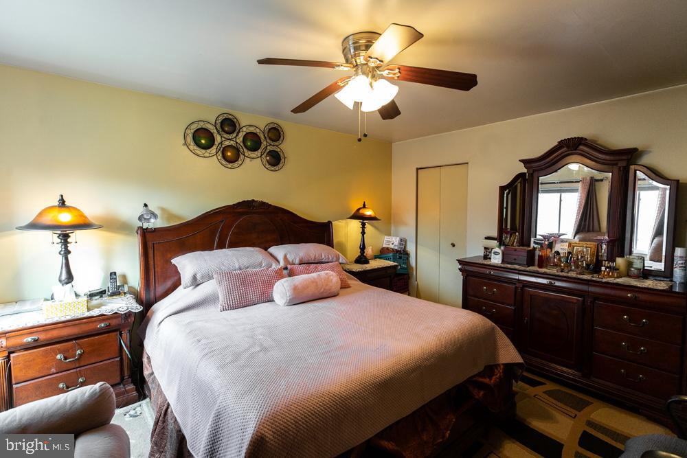 11200 Cherry Hill Road, Unit 54 Beltsville, MD 20705 - Photo 10 of 18 a bedroom with a bed and a chandelier