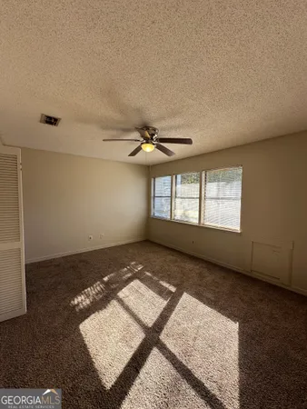 a view of empty room with ceiling fan