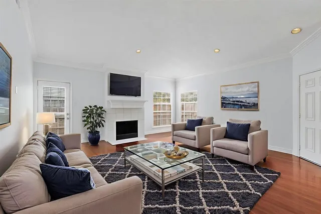 a living room with furniture a rug and a fireplace