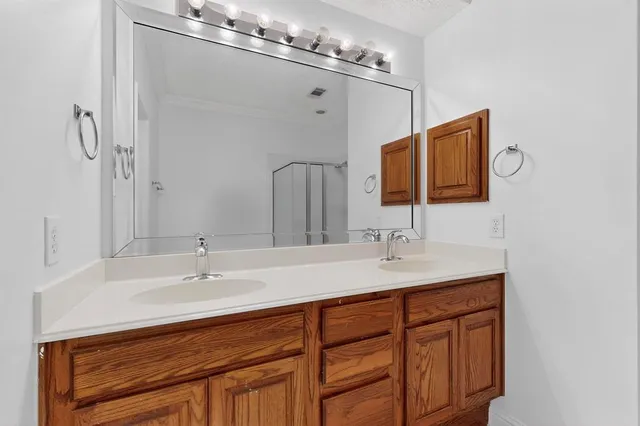 a bathroom with a sink double vanity and a mirror