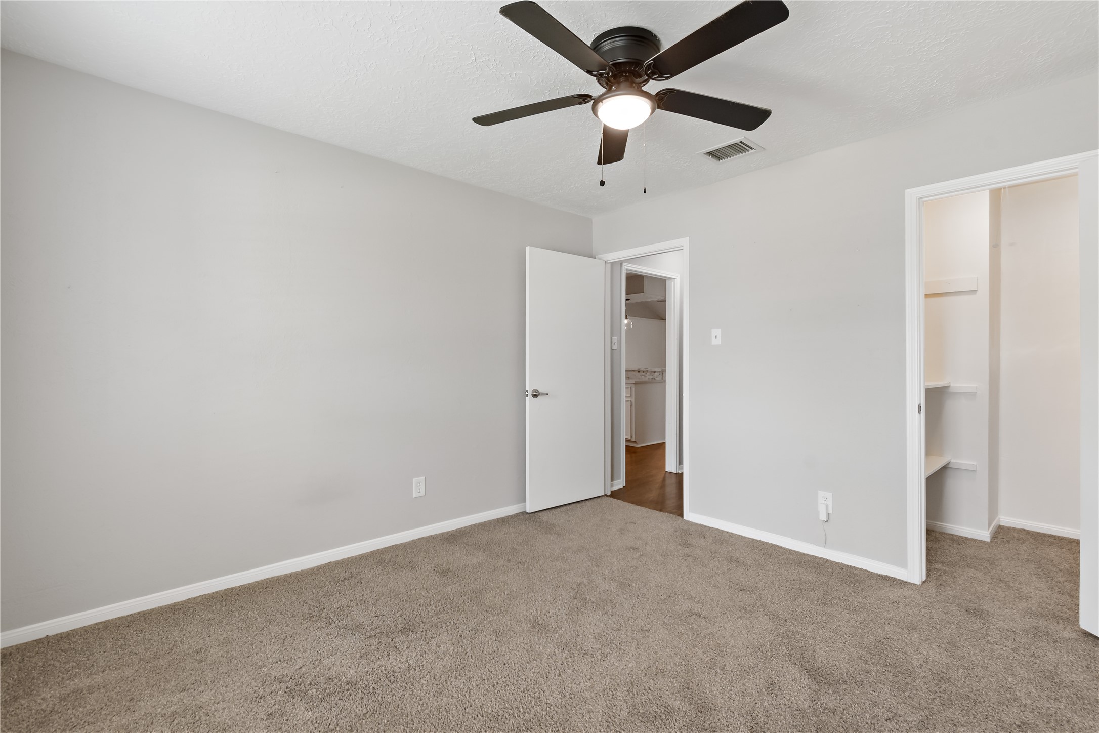 4302 Seneca Street Pasadena, TX 77504 - Photo 13 of 19 an empty room with ceiling fan and window