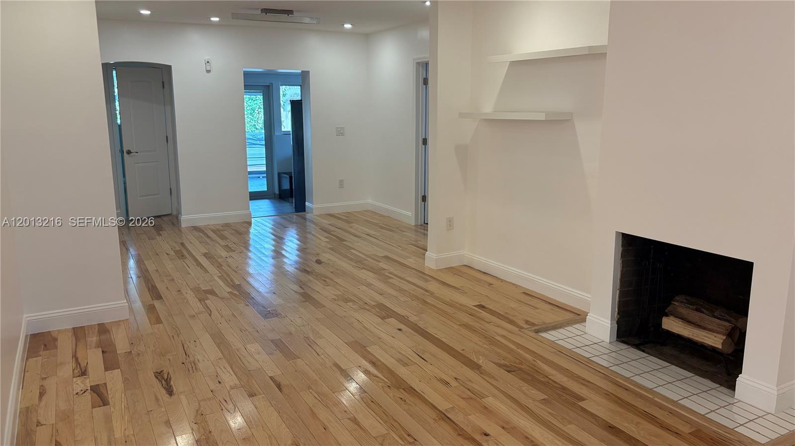 250 Southwest 19th Road Miami, FL 33129 - Photo 6 of 22 a view of hallway with wooden floor and fire place