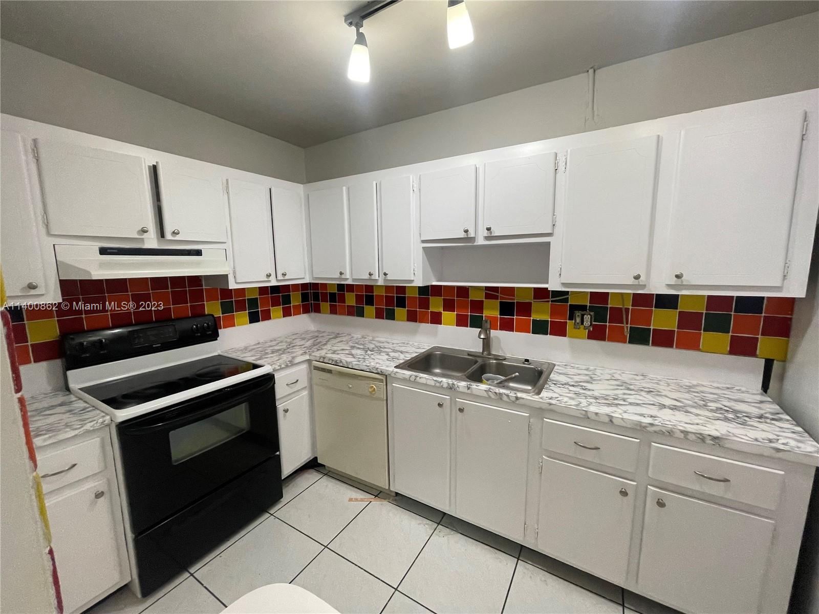 1420 Atlantic Shores Boulevard, Unit 326 Hallandale Beach, FL 33009 - Photo 2 of 16 a kitchen with stainless steel appliances granite countertop a sink stove and cabinets