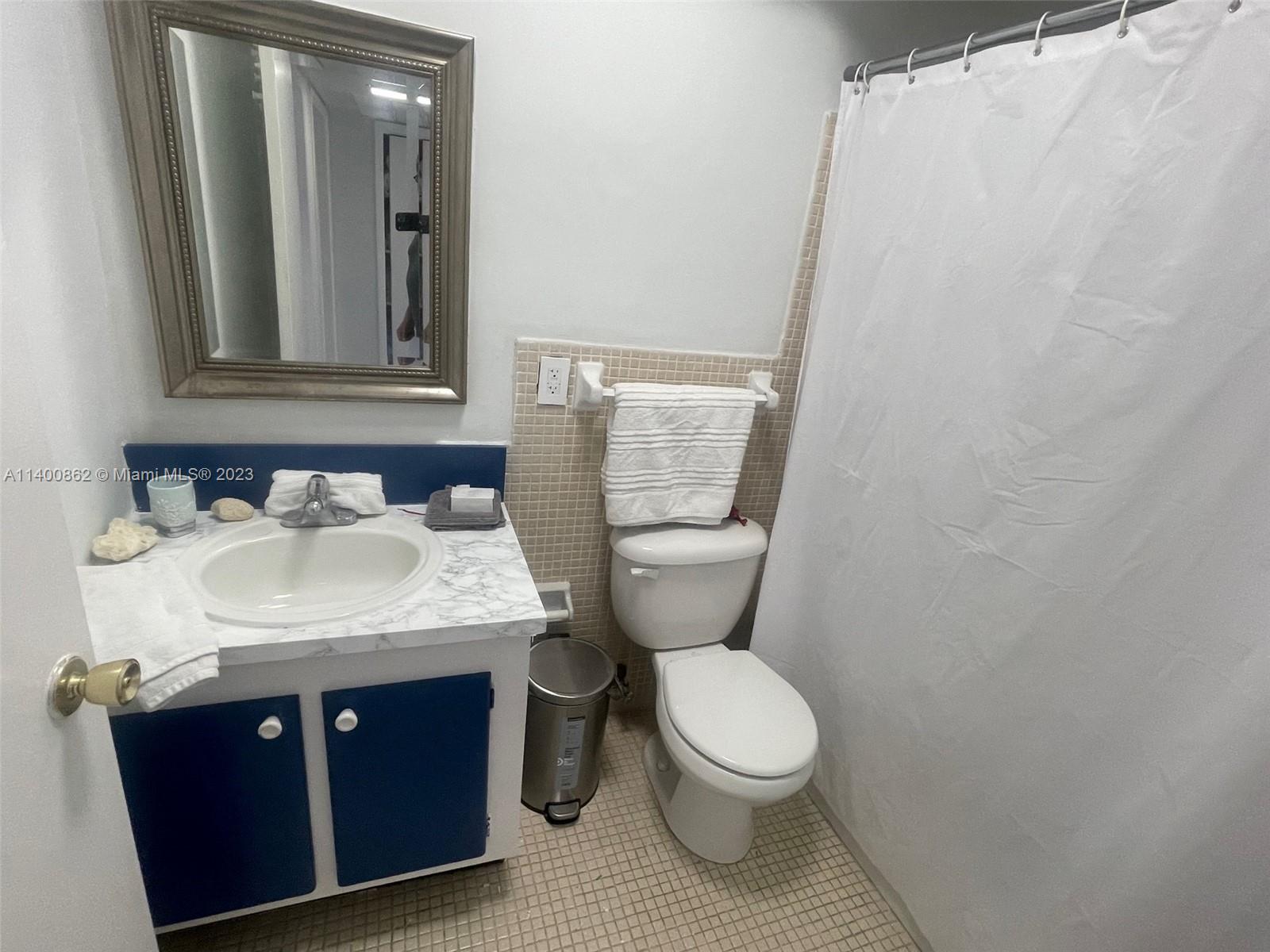 1420 Atlantic Shores Boulevard, Unit 326 Hallandale Beach, FL 33009 - Photo 4 of 16 a bathroom with a sink and a mirror