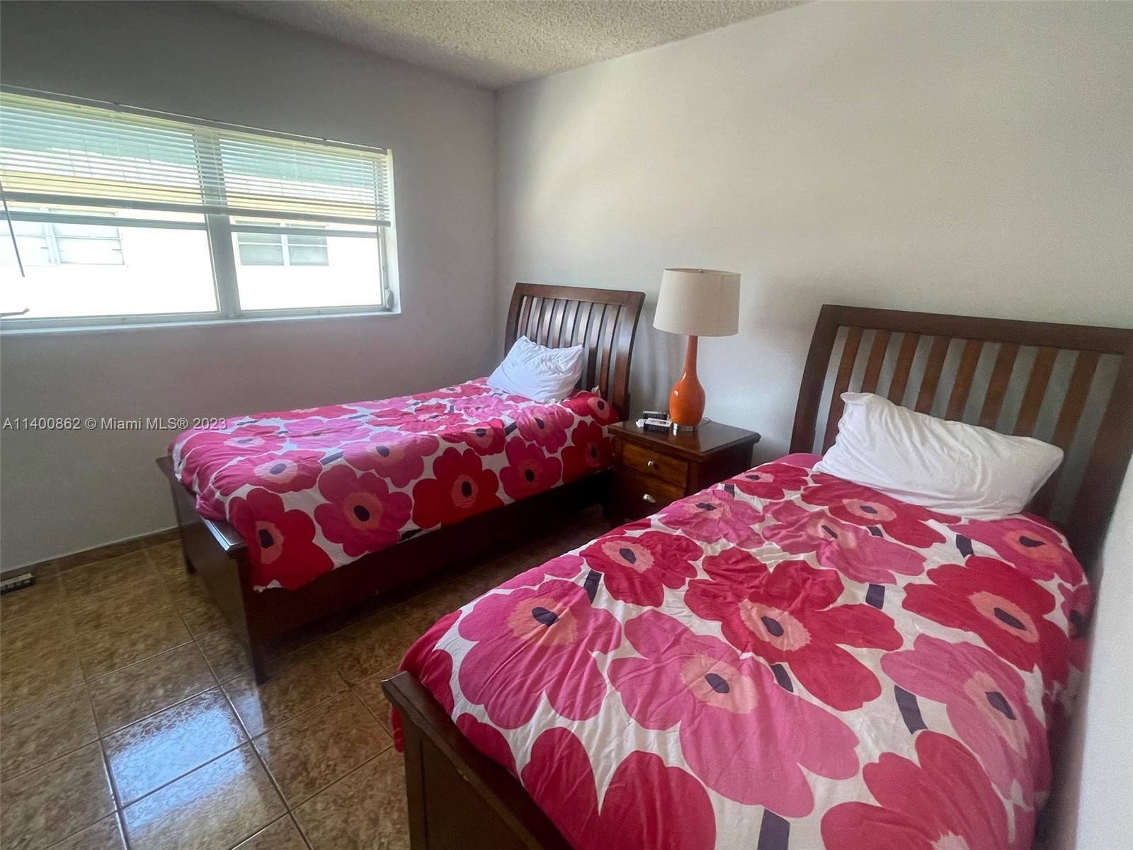 1420 Atlantic Shores Boulevard, Unit 326 Hallandale Beach, FL 33009 - Photo 5 of 16 a bedroom with two beds and a window