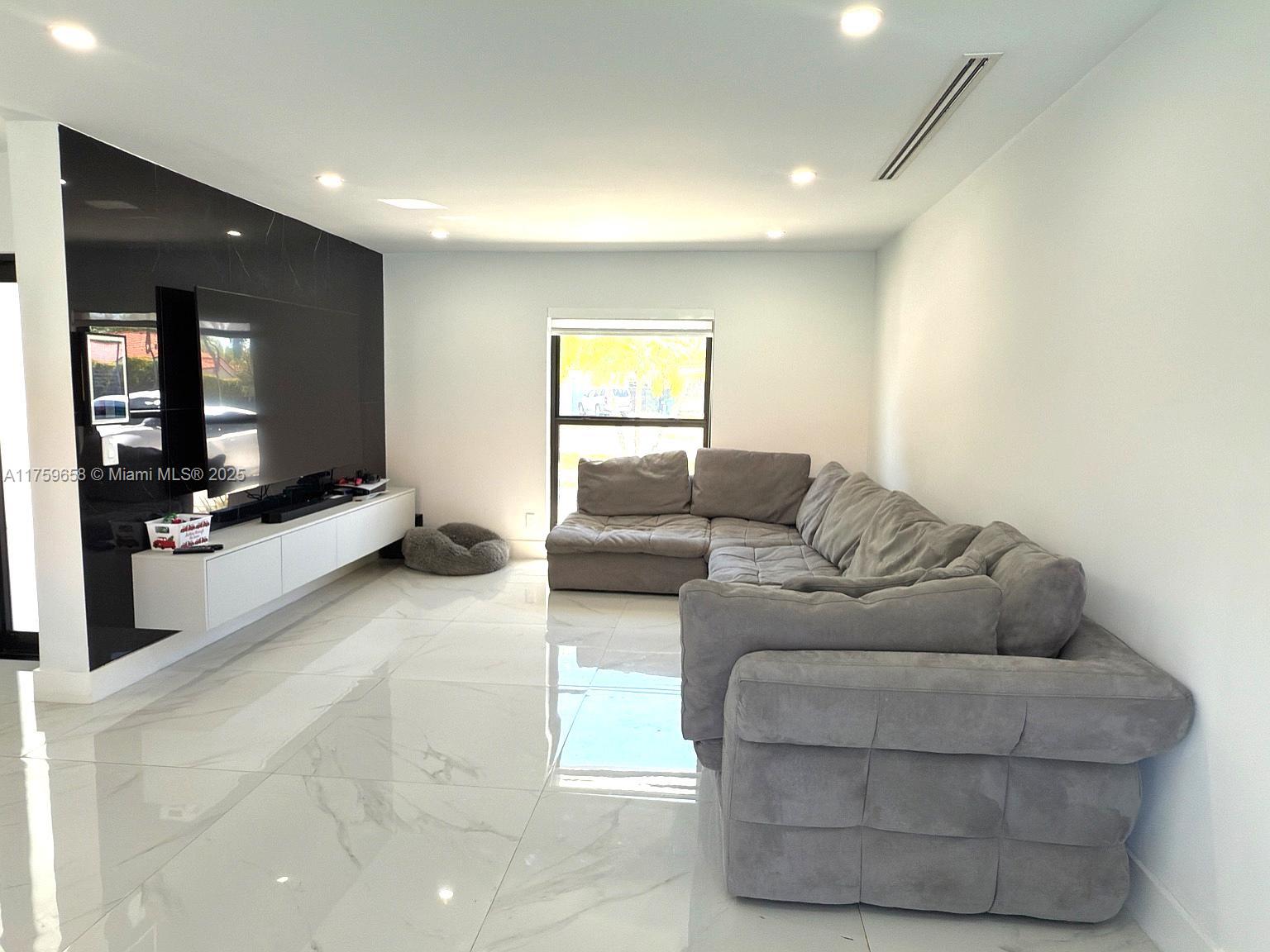 9101 Southwest 11th Street Miami, FL 33174 - Photo 11 of 25 a living room with furniture and a flat screen tv
