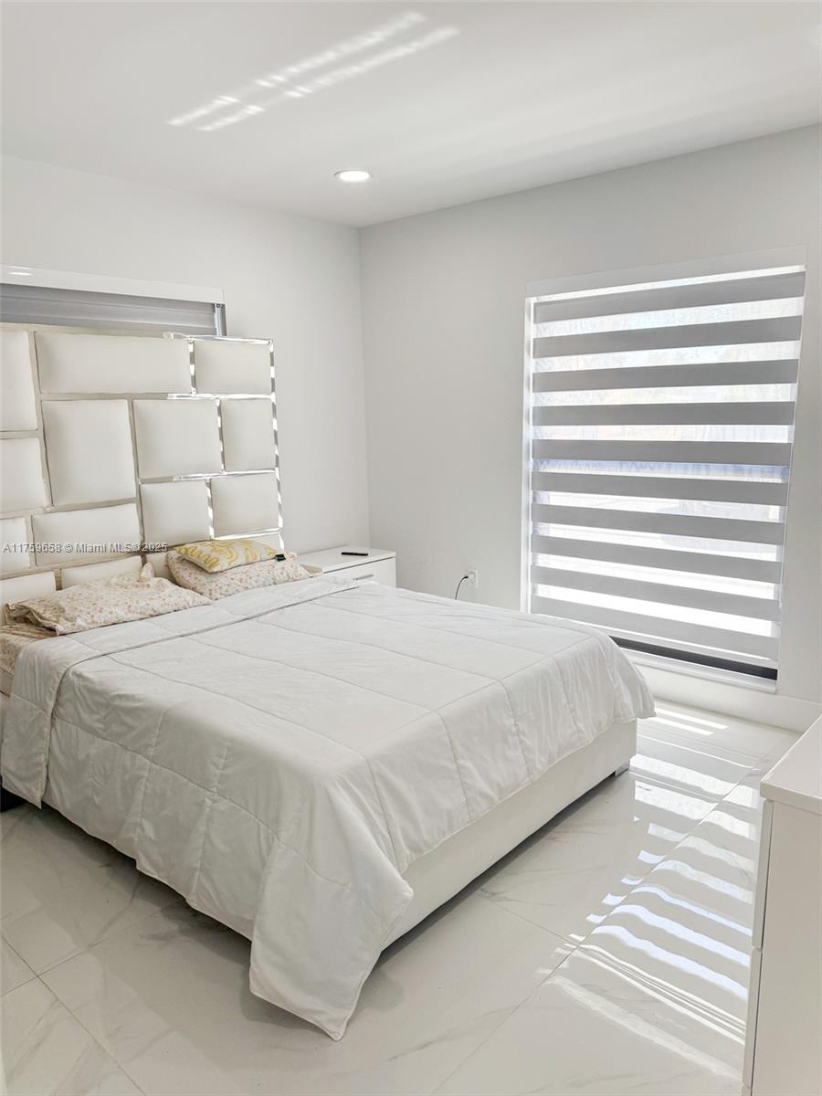 9101 Southwest 11th Street Miami, FL 33174 - Photo 13 of 25 a bedroom with a bed and a window