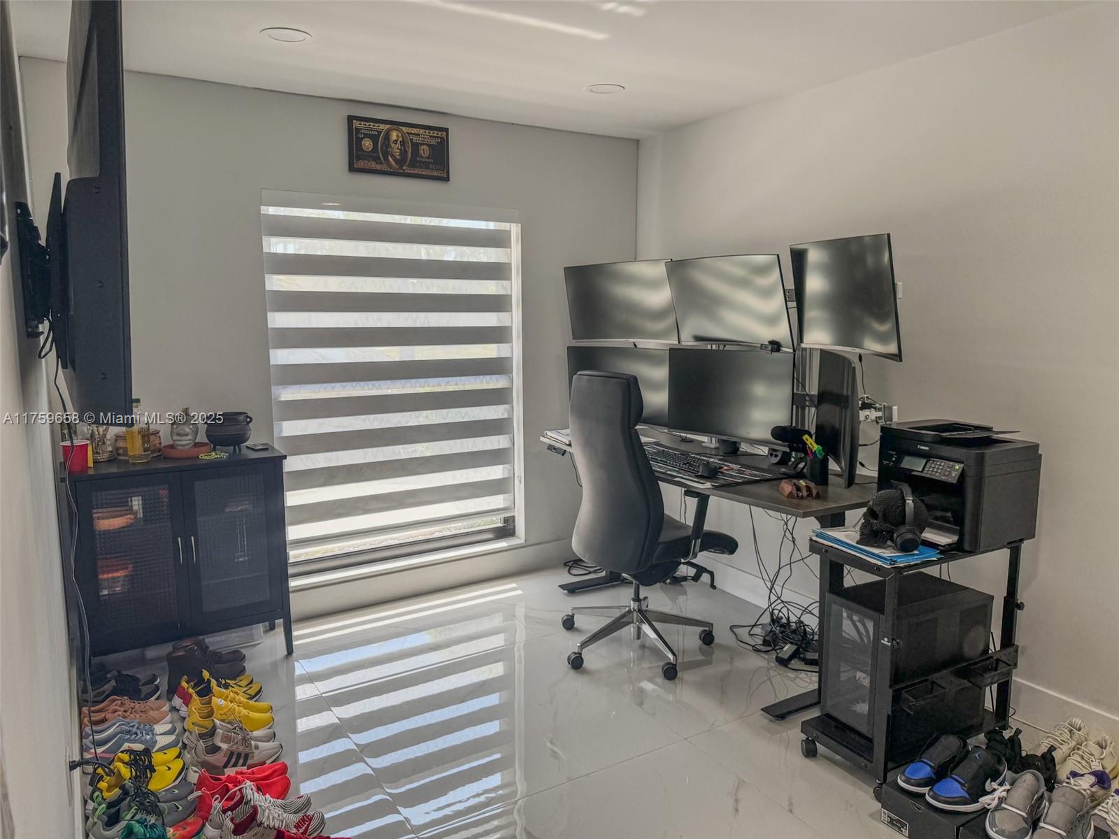 9101 Southwest 11th Street Miami, FL 33174 - Photo 14 of 25 a view of a workspace with furniture and a gate