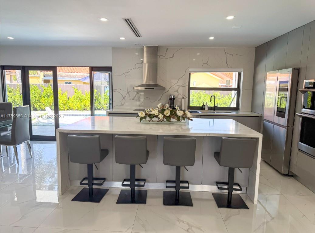 9101 Southwest 11th Street Miami, FL 33174 - Photo 5 of 25 a kitchen with a table chairs sink and cabinets