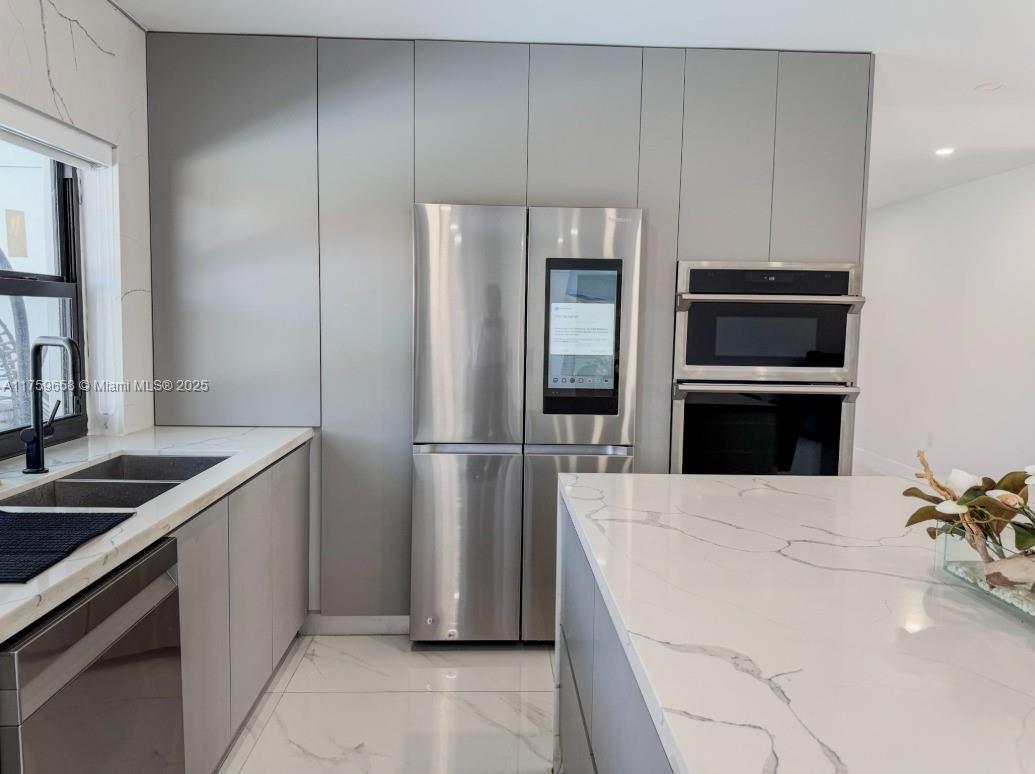 9101 Southwest 11th Street Miami, FL 33174 - Photo 6 of 25 a kitchen with granite countertop a refrigerator and a stove
