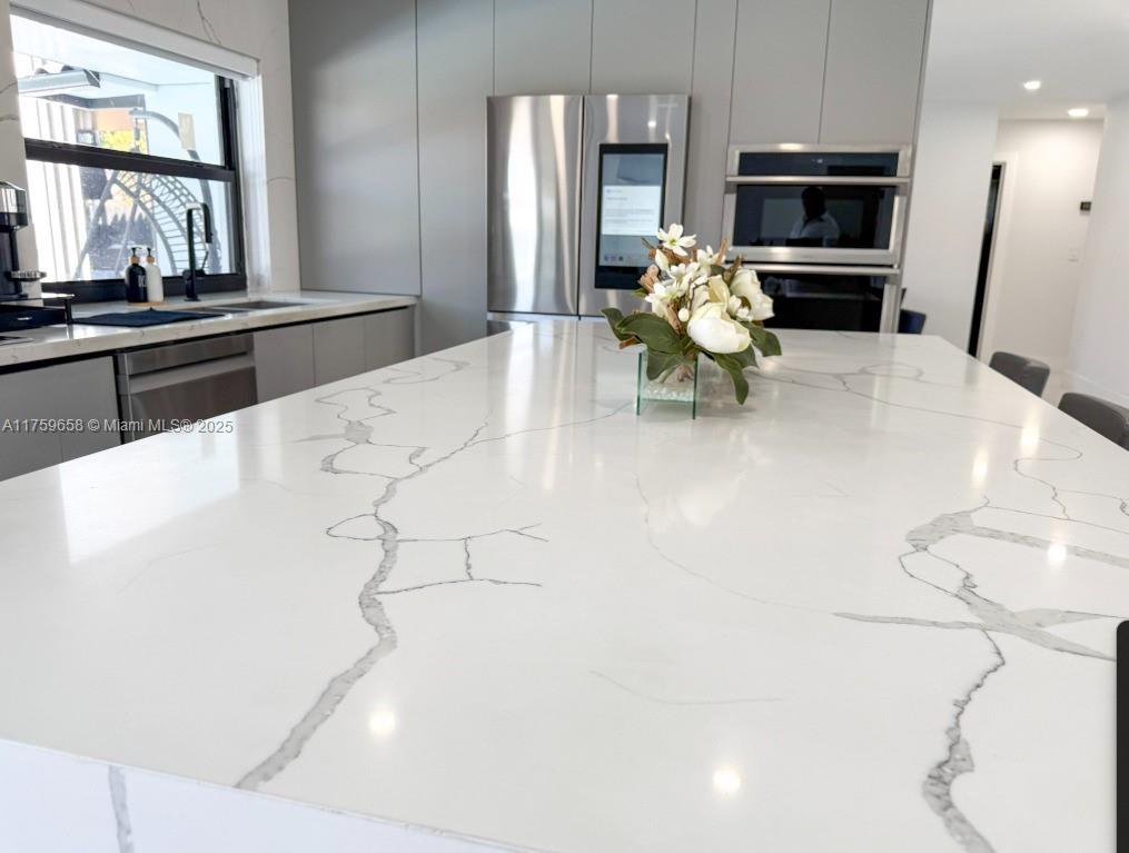 9101 Southwest 11th Street Miami, FL 33174 - Photo 7 of 25 a kitchen with stainless steel appliances kitchen island granite countertop a refrigerator and a stove