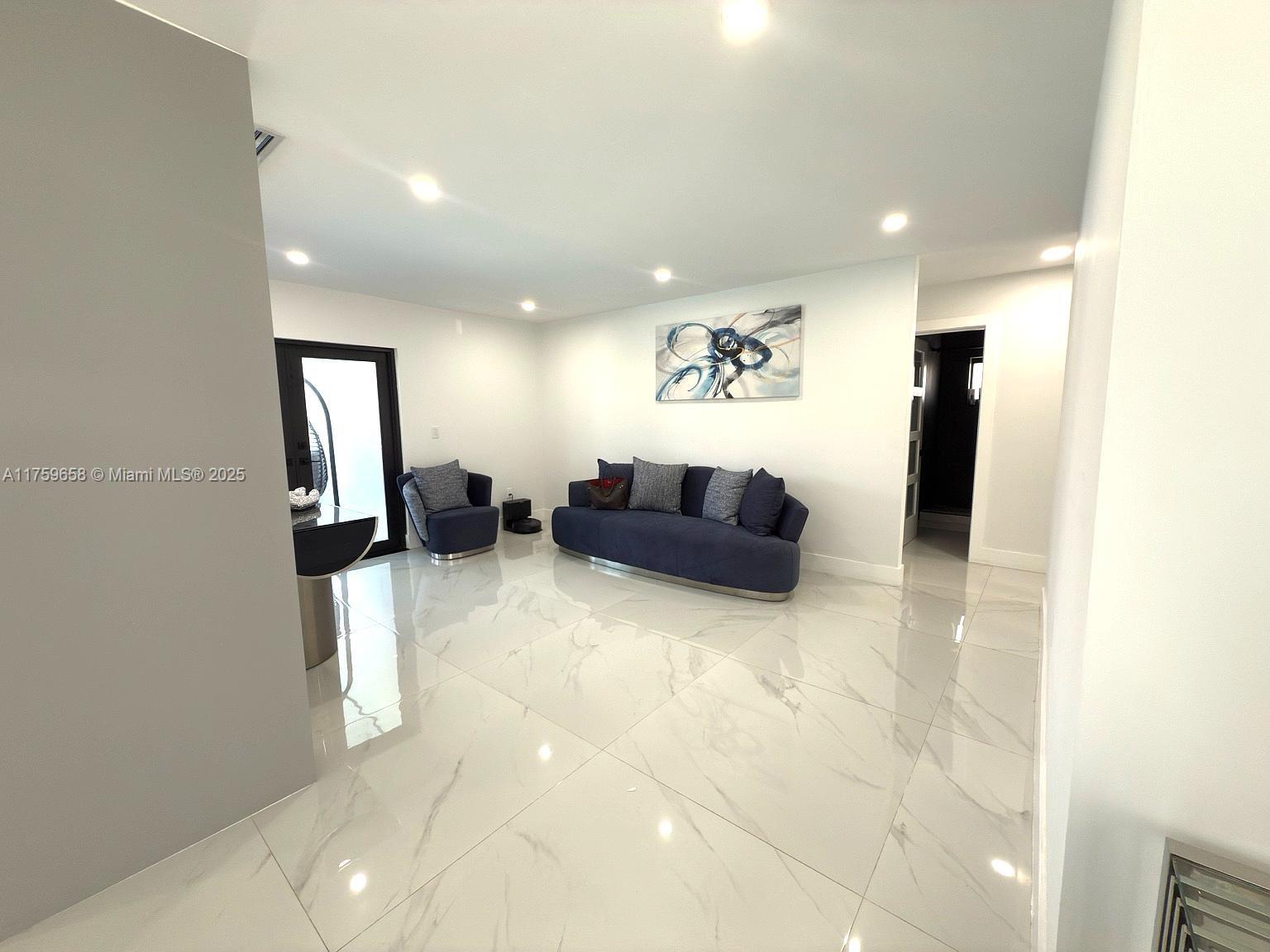 9101 Southwest 11th Street Miami, FL 33174 - Photo 10 of 25 a view of a livingroom with furniture and a flat screen tv