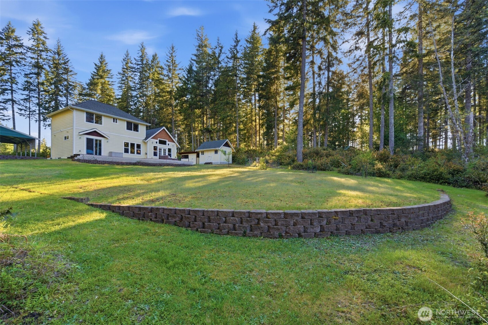 6971 Northeast Tahuya Blacksmith Road Belfair, WA 98528 - Photo 33 of 38 a view of a house with swimming pool and a big yard