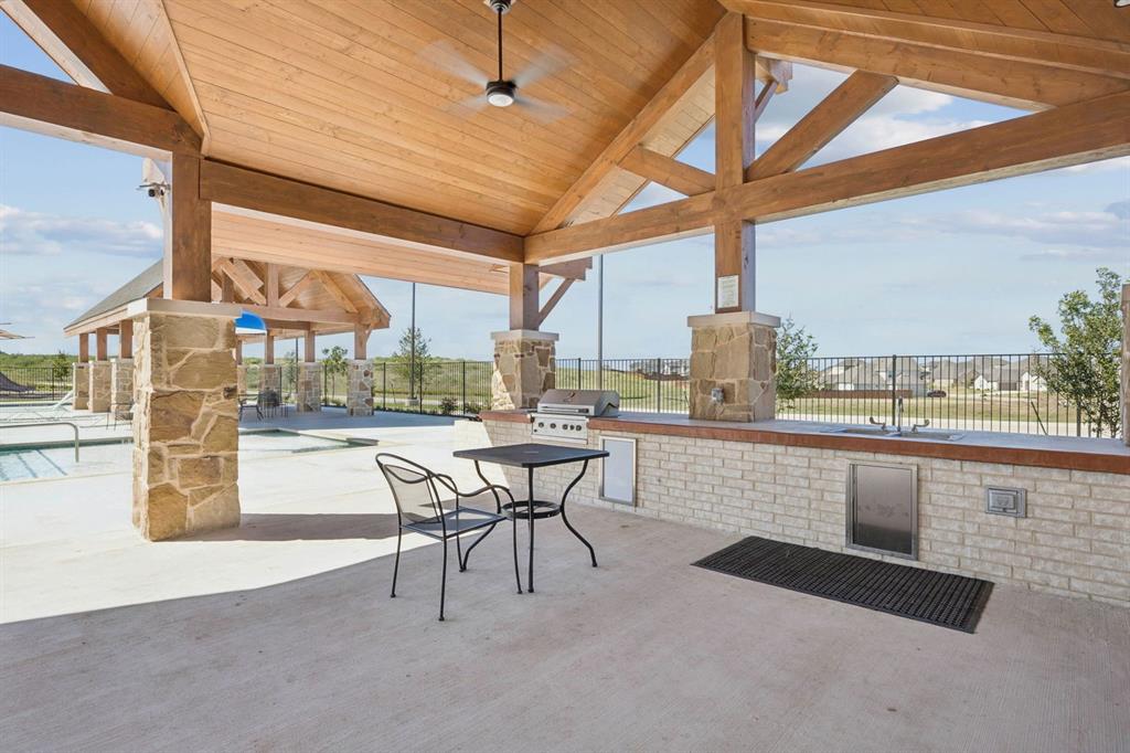 744 Carriage Hl Road Midlothian, TX 76065 - Photo 21 of 23 a dining hall with stainless steel appliances a table and chairs with wooden floor