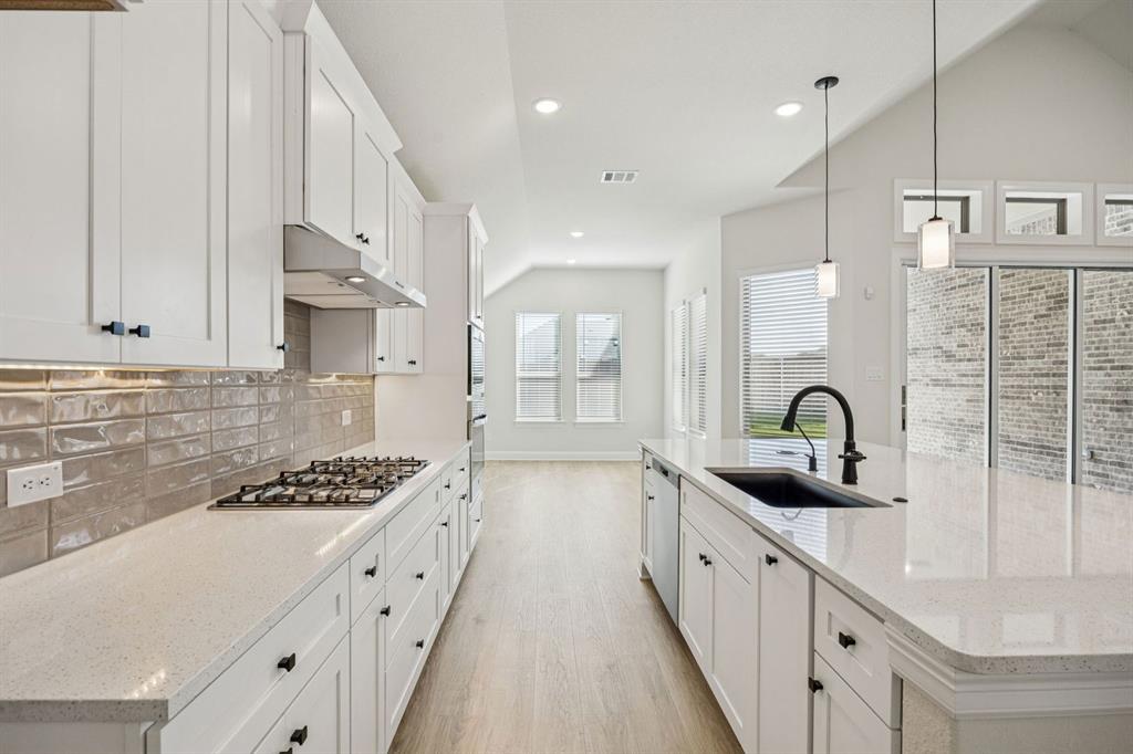744 Carriage Hl Road Midlothian, TX 76065 - Photo 5 of 23 a kitchen with stainless steel appliances a sink stove and cabinets