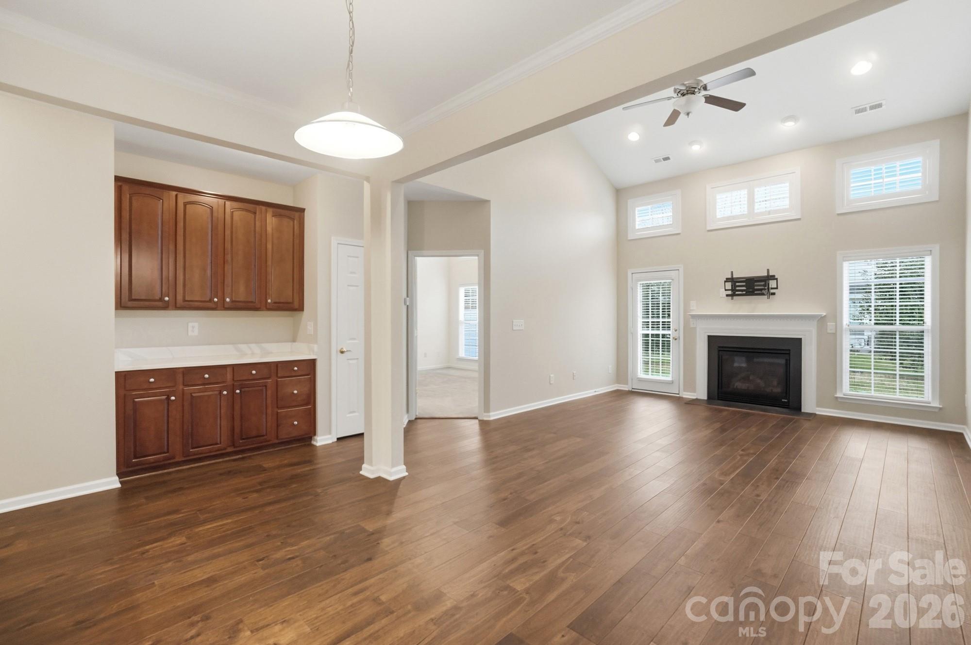284 Garnet Court Fort Mill, SC 29708 - Photo 13 of 42 a view of an empty room with wooden floor and a fireplace