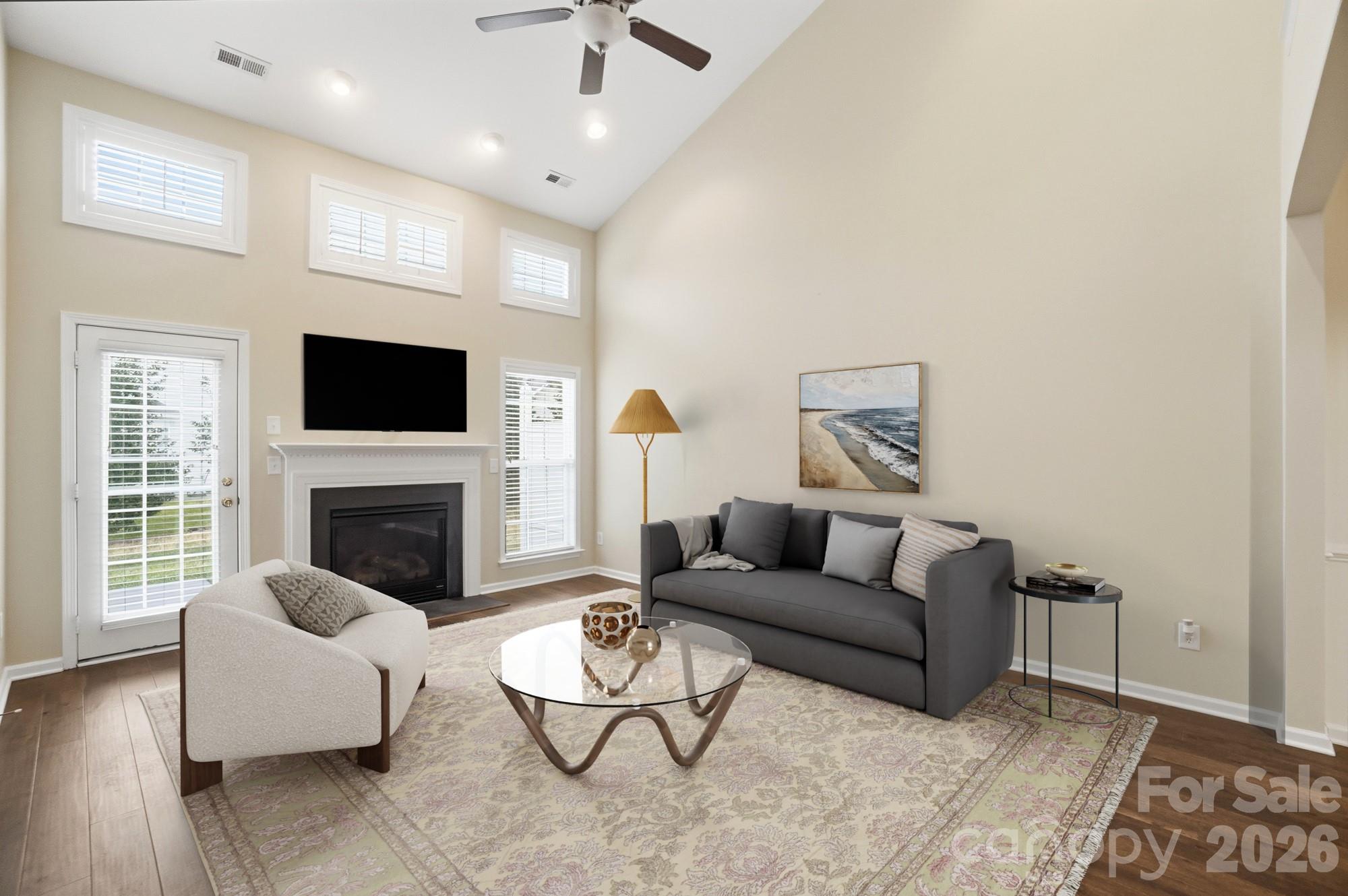 284 Garnet Court Fort Mill, SC 29708 - Photo 15 of 42 a living room with furniture a flat screen tv and a fireplace