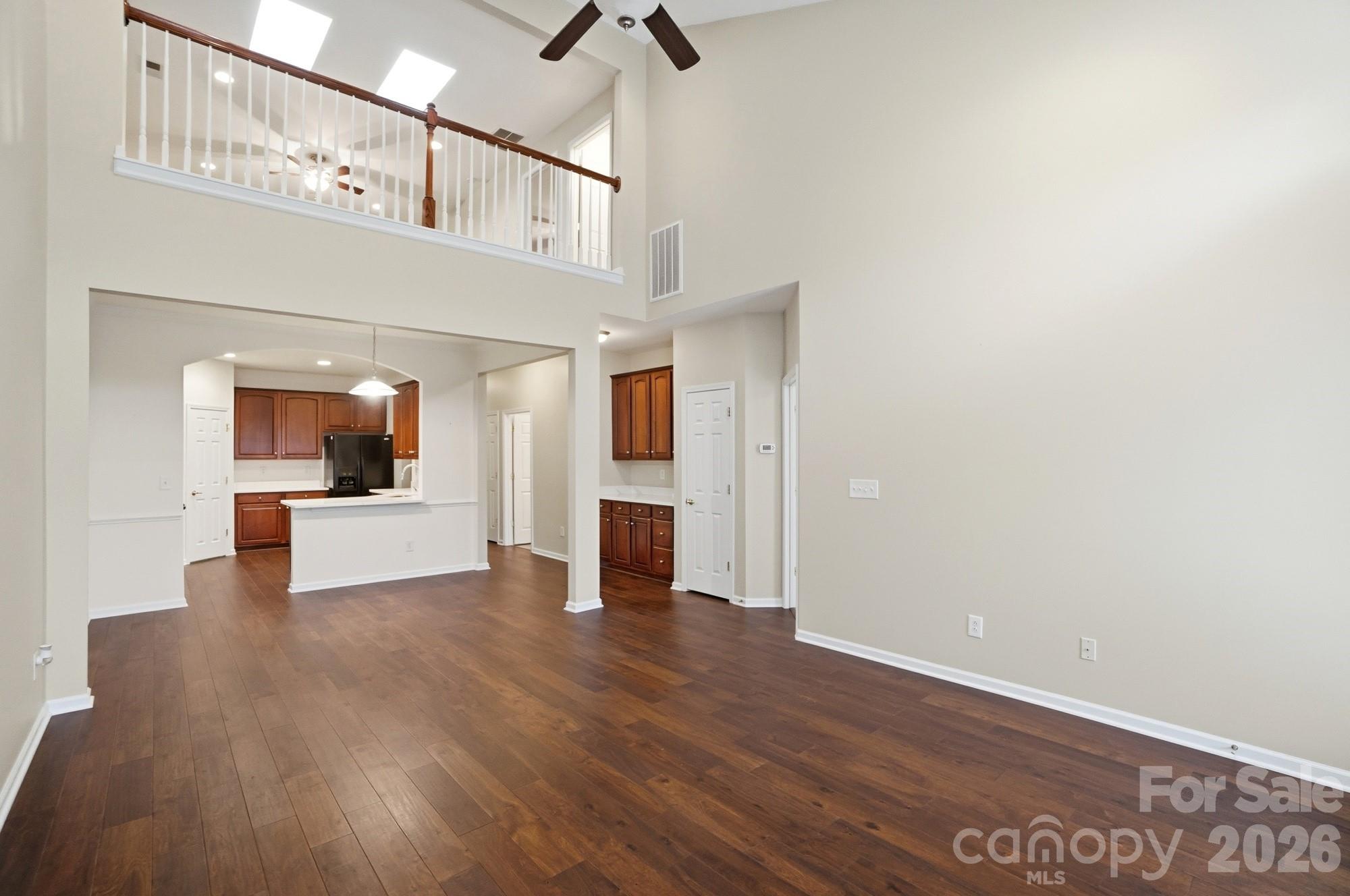 284 Garnet Court Fort Mill, SC 29708 - Photo 18 of 42 a view of a hallway with wooden floor and a kitchen