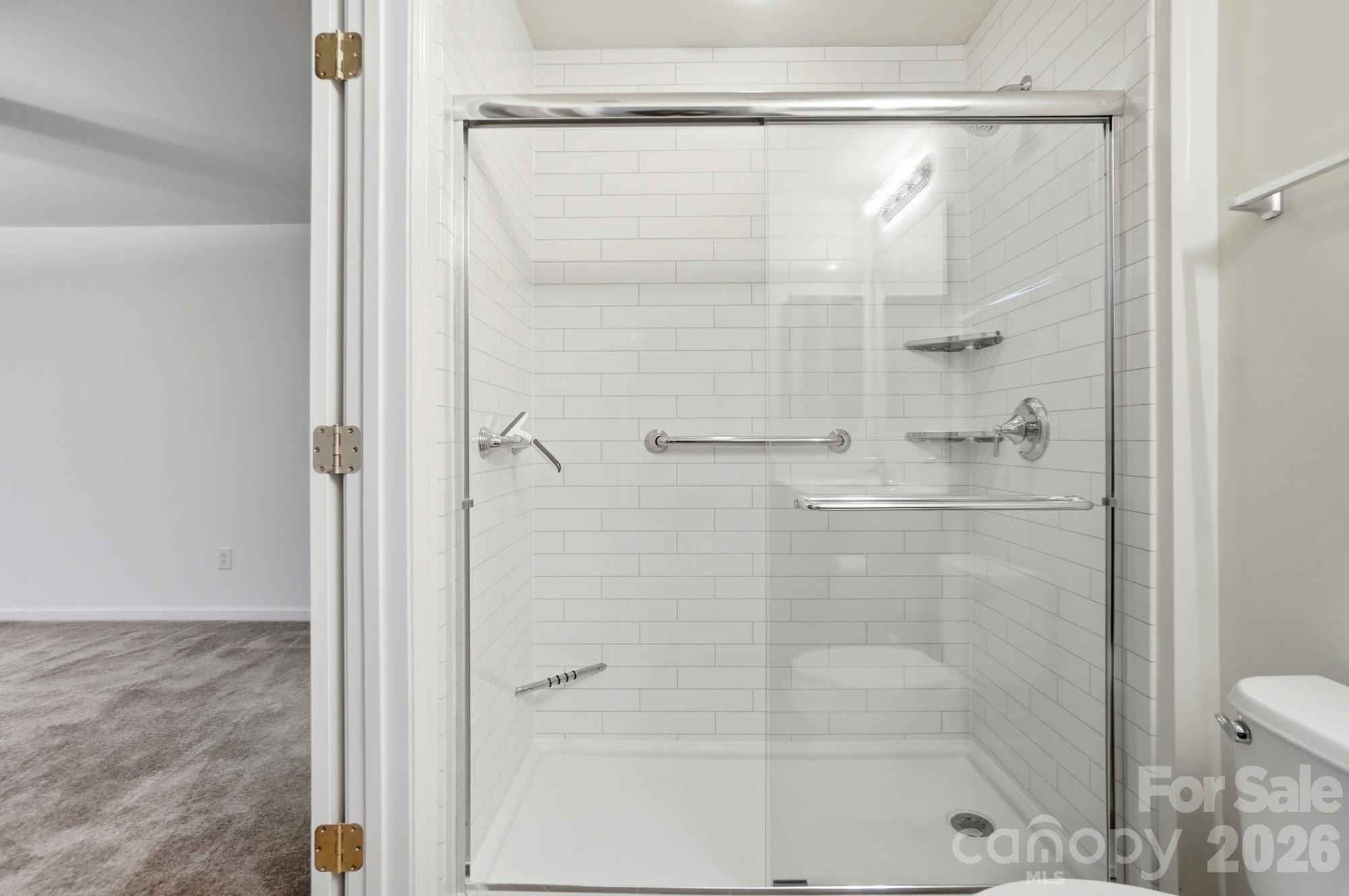 284 Garnet Court Fort Mill, SC 29708 - Photo 31 of 42 a bathroom with a glass shower door