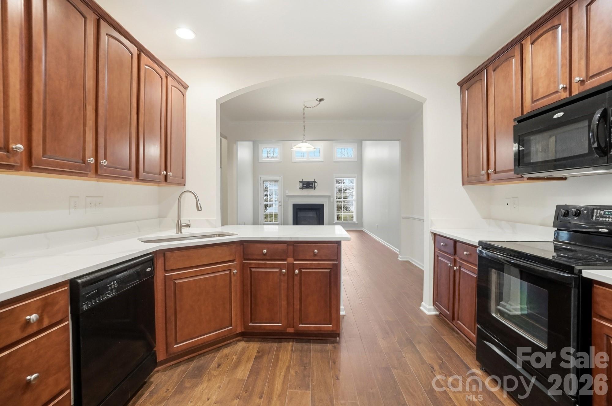 284 Garnet Court Fort Mill, SC 29708 - Photo 7 of 42 a kitchen with stainless steel appliances granite countertop wooden cabinets a sink a stove a oven and dishwasher with wooden floor