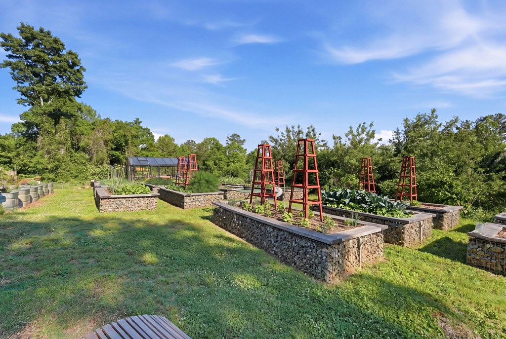 1823 Shoal Creek Road Clarkesville, GA 30523 - Photo 115 of 149 a view of a swimming pool with a patio and a garden