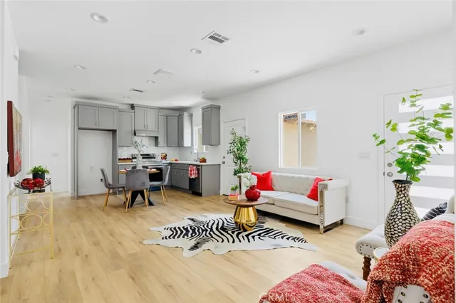 a living room with furniture and a potted plant