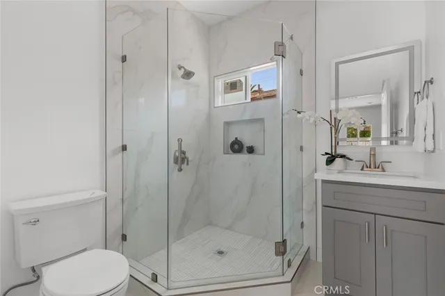 a bathroom with a shower a toilet and sink