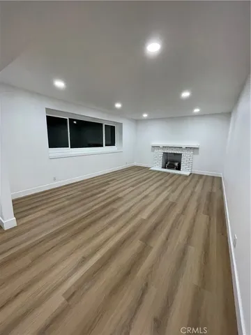 a view of a livingroom with an empty space and a window