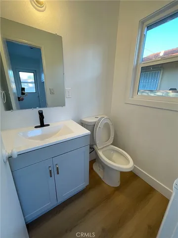 a bathroom with a toilet a sink and mirror