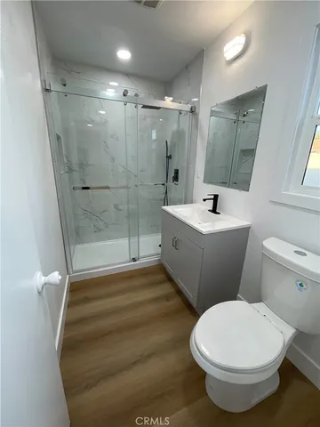 a bathroom with a sink toilet and shower