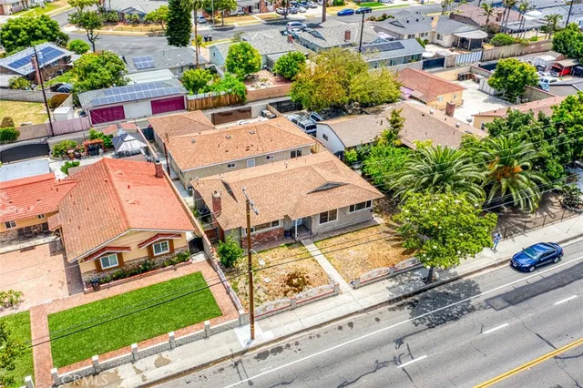 an aerial view of a house with garden space and street view