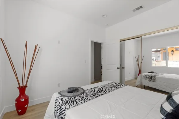 a bedroom with a bed and a chair