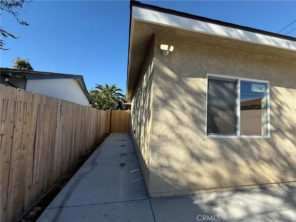 a front view of a house with a tree