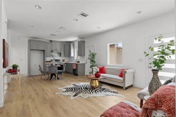 a living room with furniture and a potted plant
