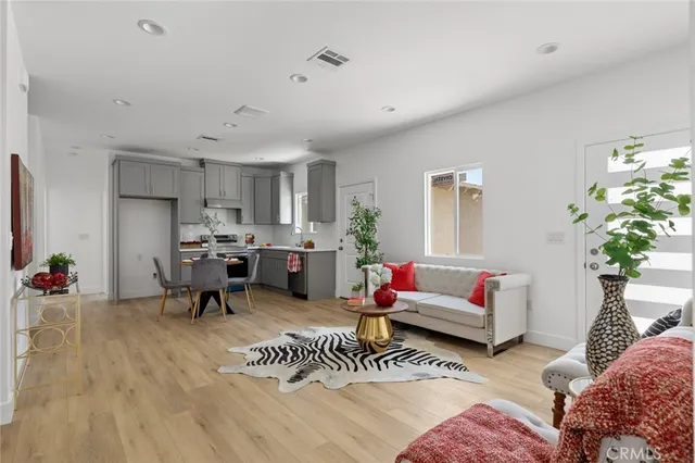 a living room with furniture and a potted plant