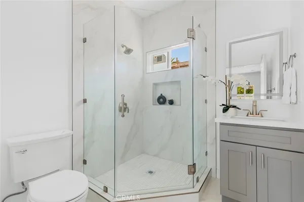 a bathroom with a shower a toilet and sink