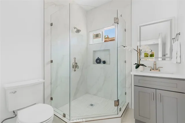 a bathroom with a shower a toilet and sink