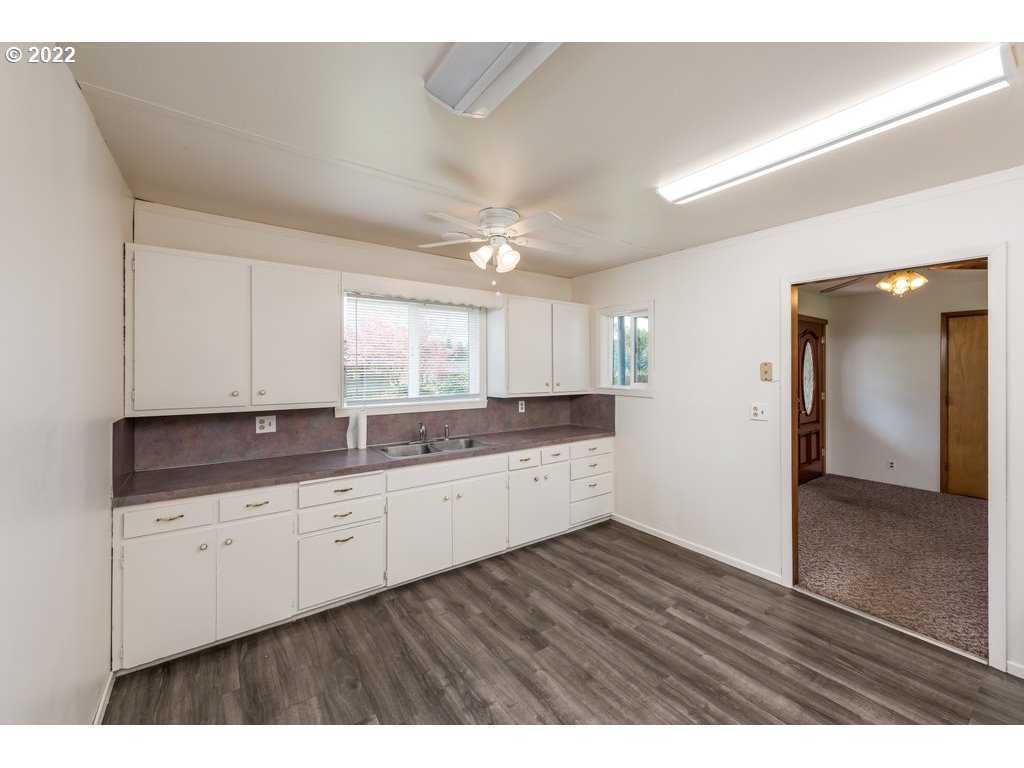 21941 South Schieffer Road Colton, OR 97017 - Photo 7 of 23 a kitchen with granite countertop a sink and a wooden floor