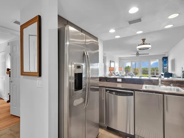 a kitchen with stainless steel appliances granite countertop a sink and cabinets