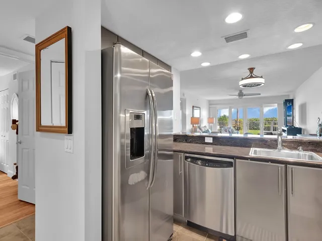 a kitchen with stainless steel appliances granite countertop a sink and cabinets