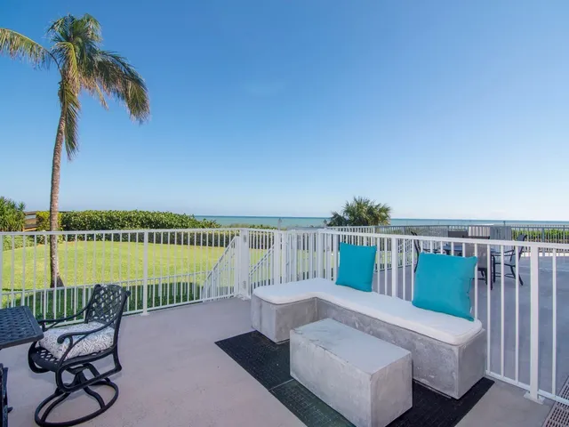 a view of a balcony with lake view and a couches